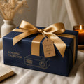 Reading projector gift wrapped in navy paper with gold ribbon